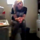 A blonde girl recites lyrics from a well-known rap song as she takes a shit while sitting on a toilet. No audible pooping sounds.
